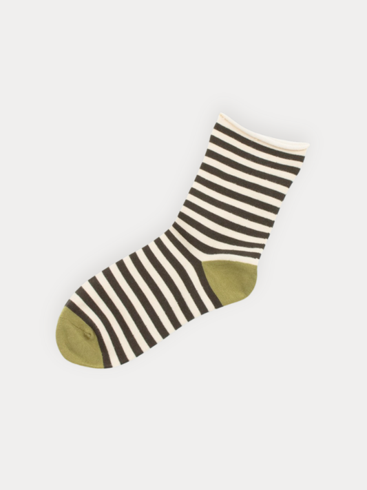 A single ankle sock with horizontal charcoal and off-white stripes, featuring an olive green toe and heel, displayed on a light gray background.