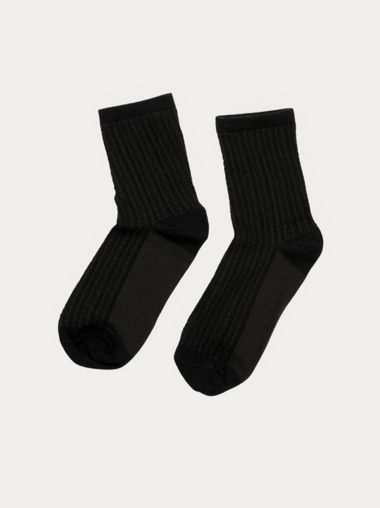 A pair of black ribbed crew socks displayed against a light gray background.
