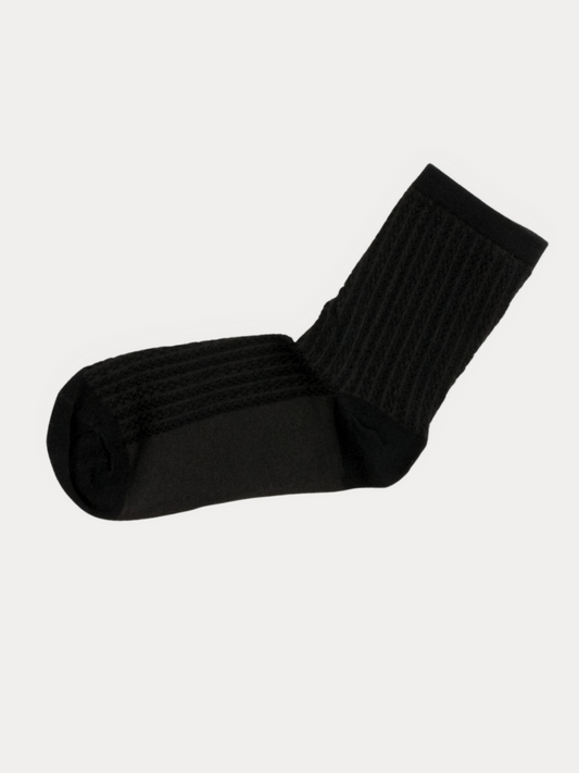 A single black ribbed crew sock shown against a plain light gray background.