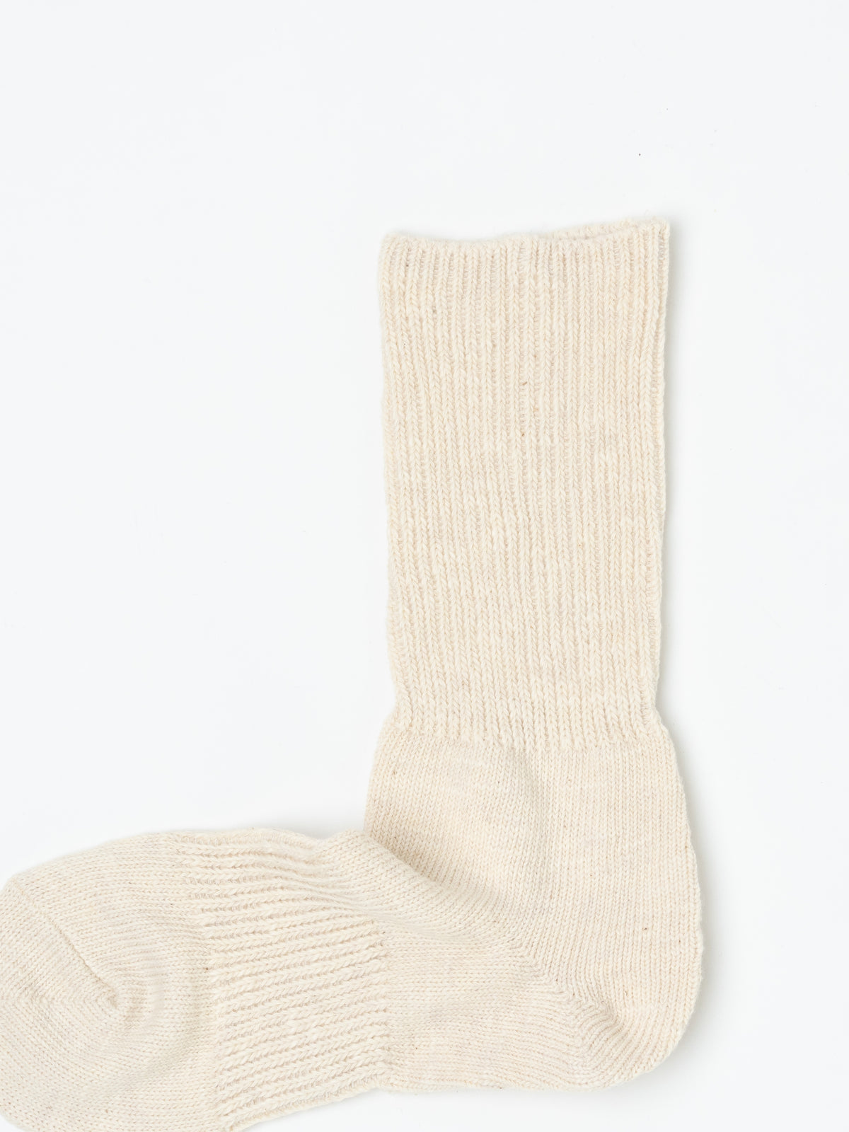 Single cream sock viewed from above, showing the ribbed texture running the full length of the leg.