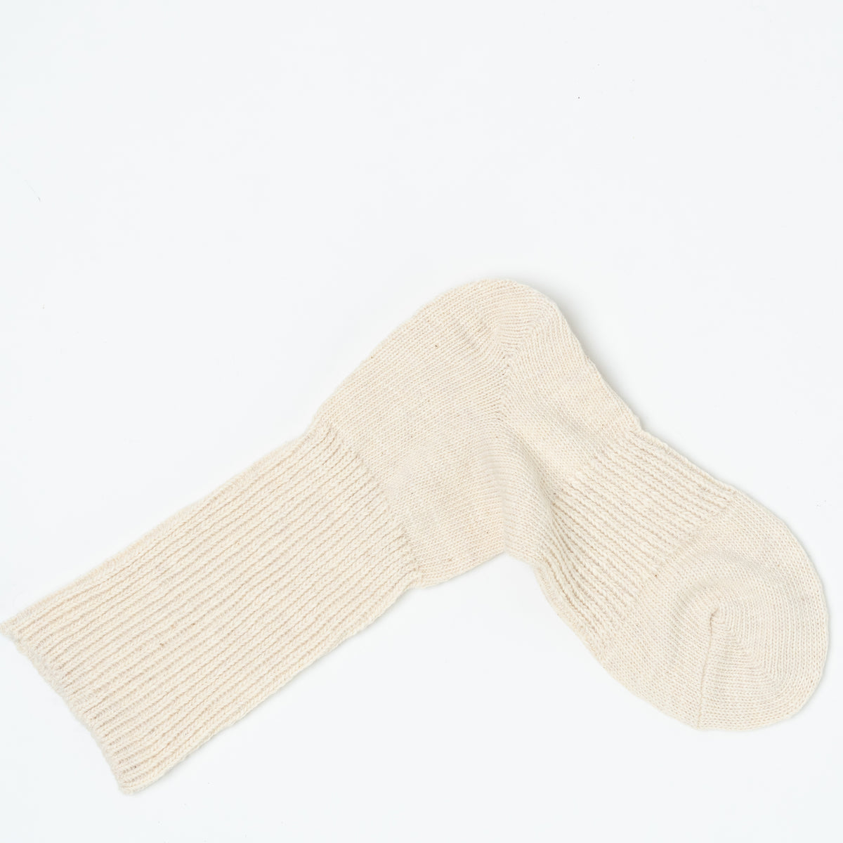 Single sock folded flat in a loose zigzag, showing the heel shaping and rounded toe.
