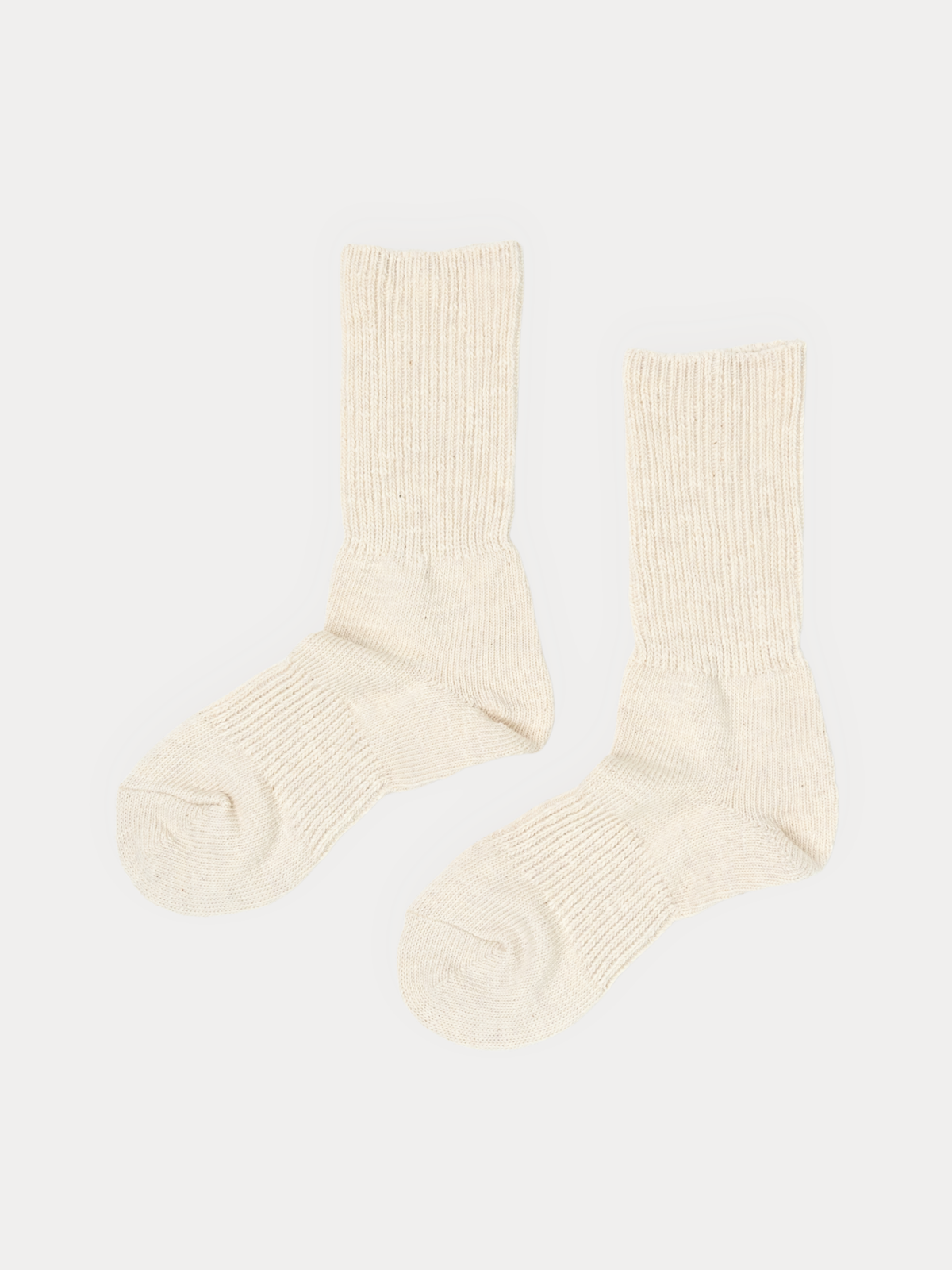Thick Cotton socks in natural cream, standing upright with a chunky ribbed knit and no pattern.