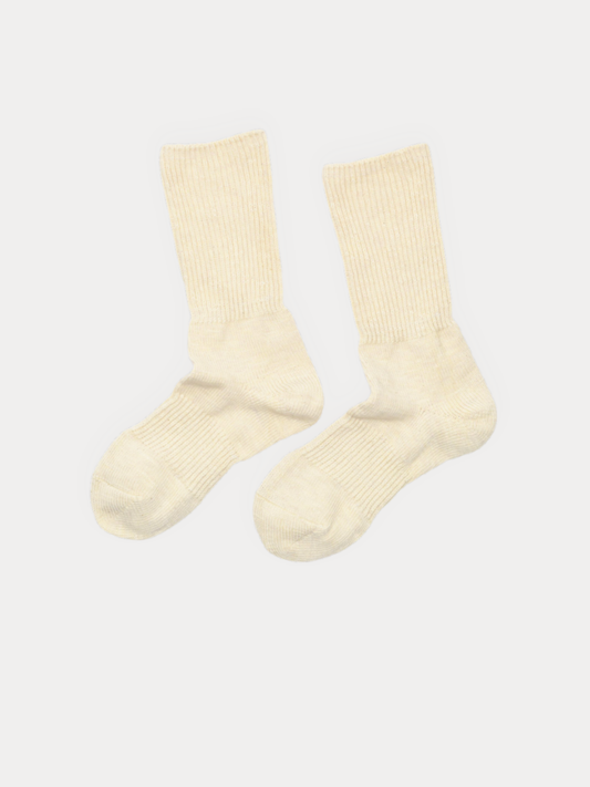 A pair of cream-colored ribbed crew socks displayed flat against a light off-white background.