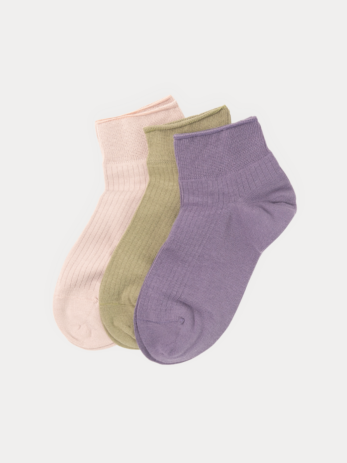 Set of three ribbed ankle socks in blush pink, sage olive, and dusty lavender, laid flat and fanned out.