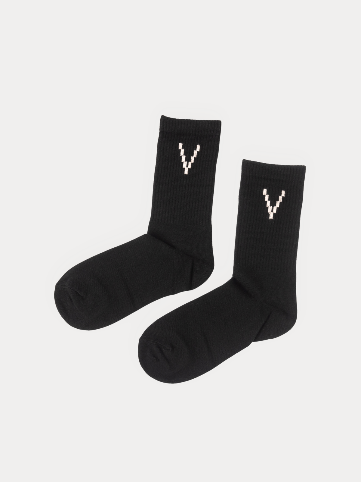 A pair of black crew socks with a white knitted 'V' logo on the cuff, displayed against a light gray background.