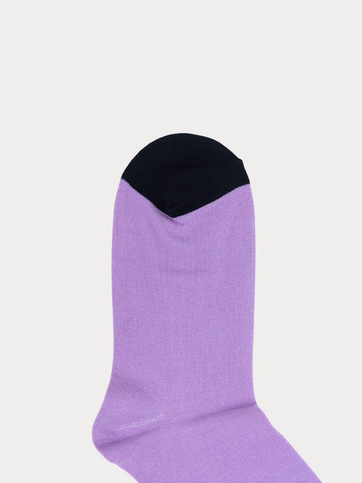 Close-up of a folded sock's toe seam, with a black toe blending into the lavender body in a V shape.