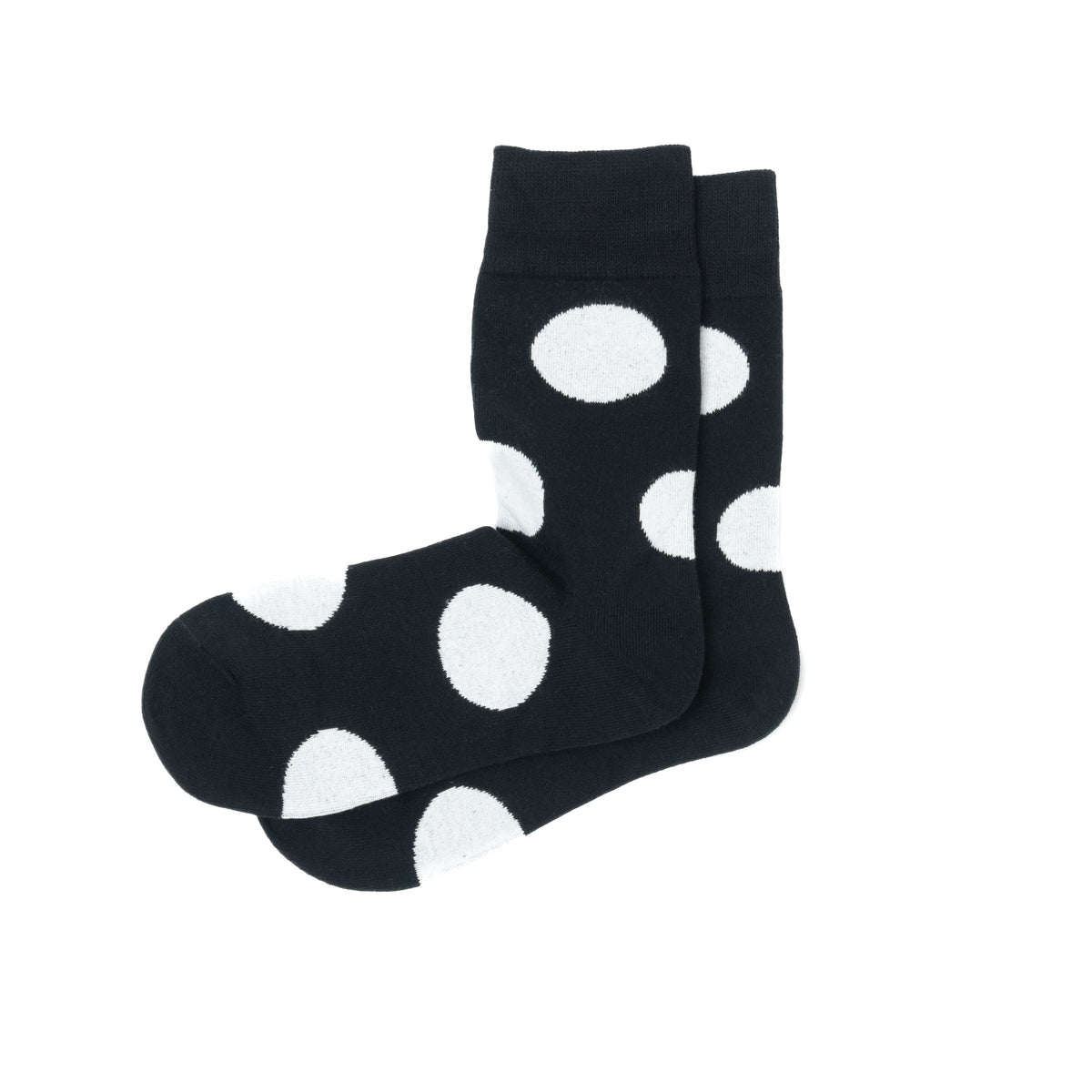 Pair of black crew socks with a bold white polka dot print, laid flat and overlapping at the ankle.
