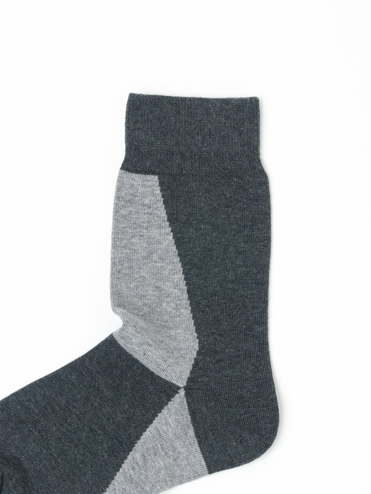 A single crew sock in dark charcoal gray with contrasting light gray geometric panels, shown on a plain white background.