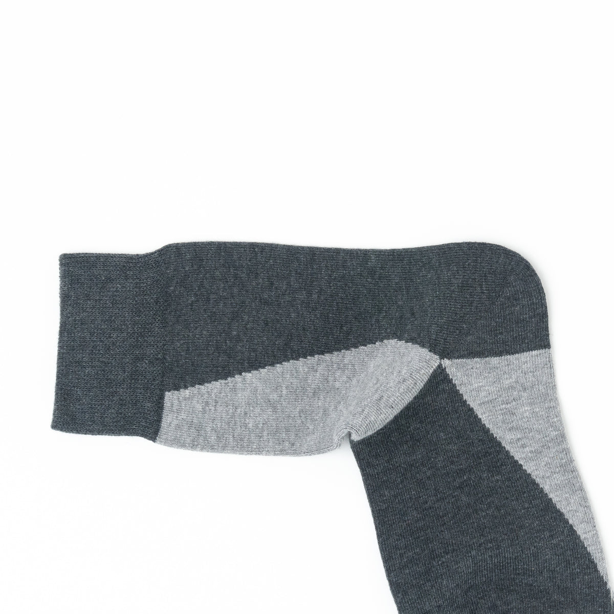 A close-up of a dark gray and light gray striped sock on a plain white background.