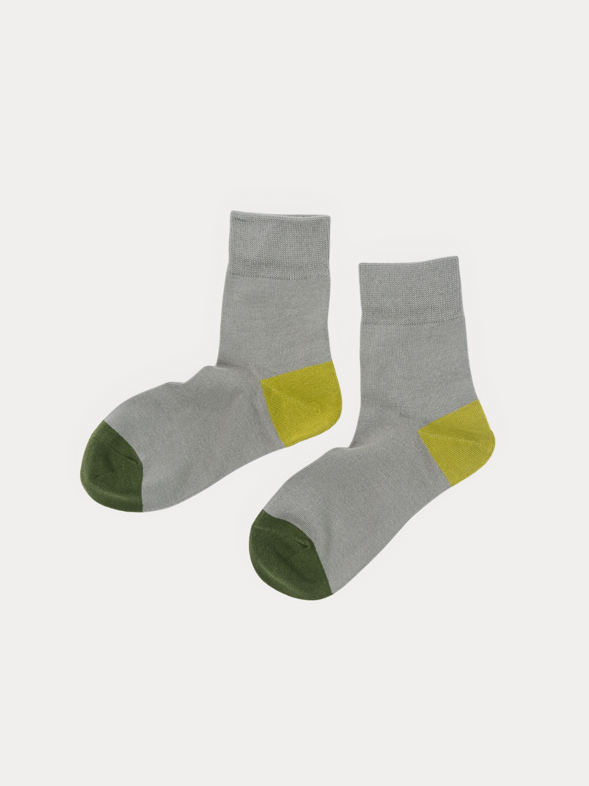 A pair of crew socks in heather gray with olive green toes and yellow heel accents, displayed against a light gray background.